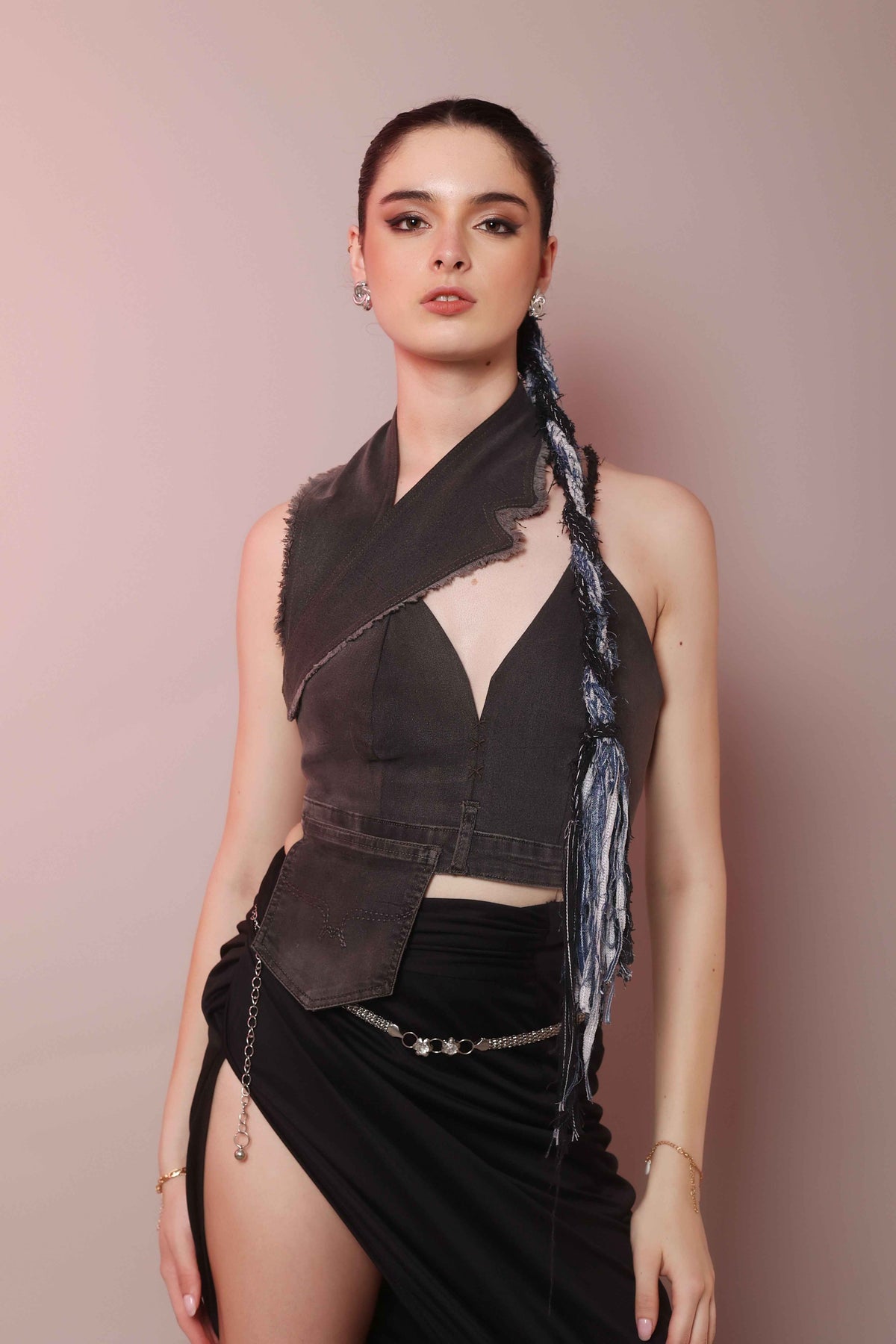Woman wearing asymmetric denim halter corset top