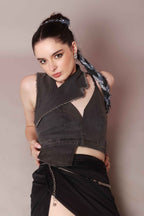 Woman wearing asymmetric denim halter corset top