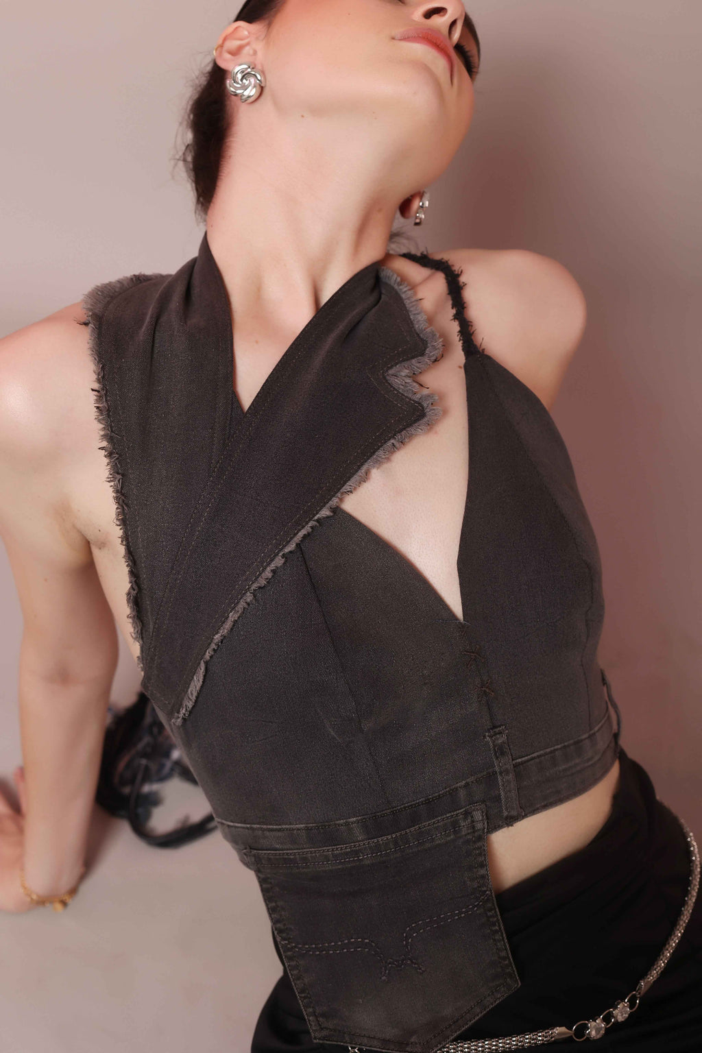 Woman wearing asymmetric denim halter corset top